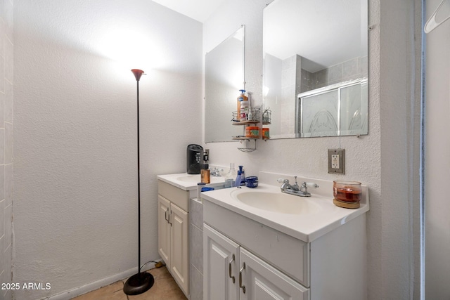 bathroom featuring vanity, tile patterned floors, and a shower with door