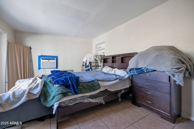 tiled bedroom featuring an AC wall unit