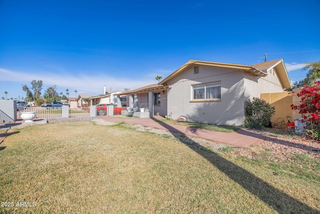 rear view of property with a lawn