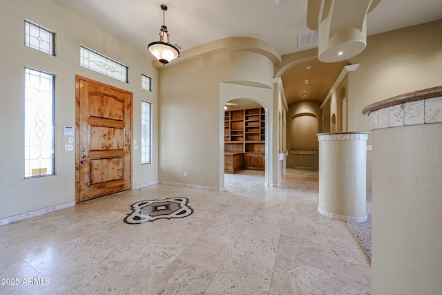 entrance foyer with a healthy amount of sunlight and a towering ceiling