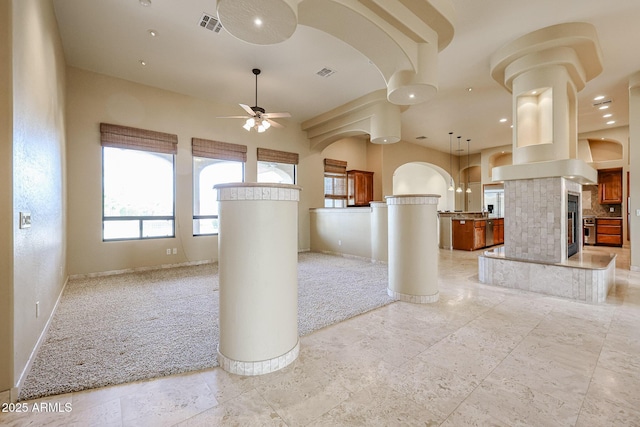 interior space with ceiling fan