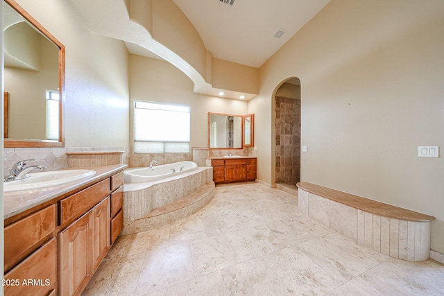 bathroom featuring vanity and shower with separate bathtub