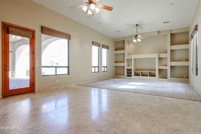 unfurnished living room with built in features and ceiling fan