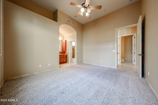 carpeted spare room with high vaulted ceiling and ceiling fan