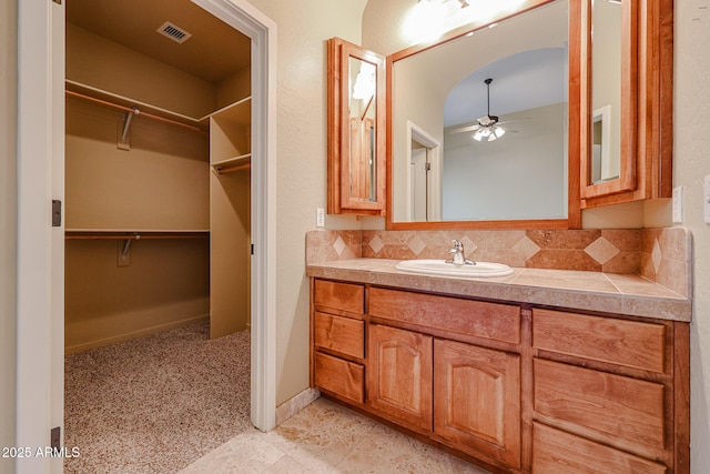 bathroom with vanity, backsplash, and ceiling fan