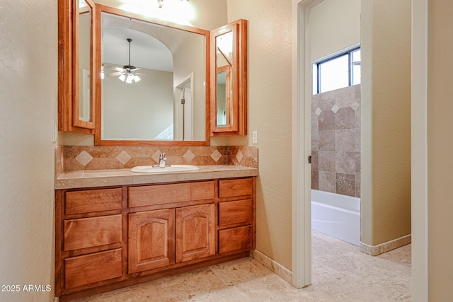 bathroom with tasteful backsplash, ceiling fan, and vanity