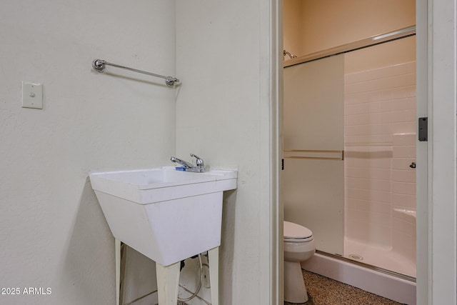 bathroom featuring walk in shower and toilet