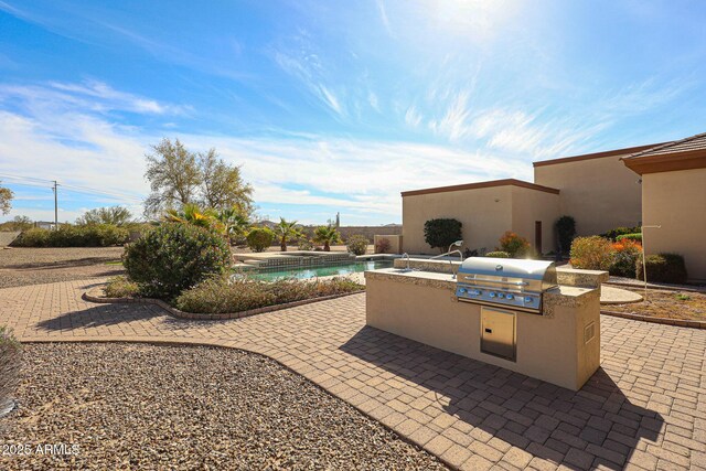 view of patio with an outdoor kitchen and area for grilling