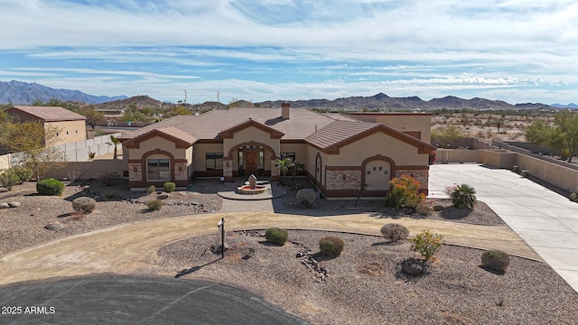 view of front of property featuring a garage and a mountain view