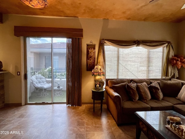 living room featuring baseboards and healthy amount of natural light