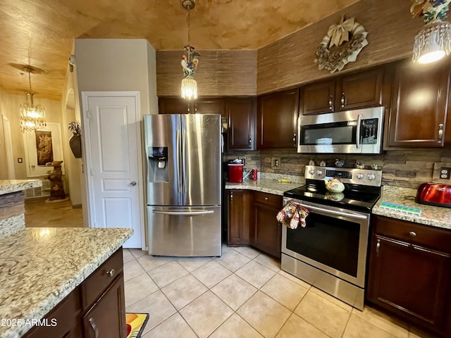 kitchen featuring appliances with stainless steel finishes, tasteful backsplash, light tile patterned floors, and dark brown cabinetry