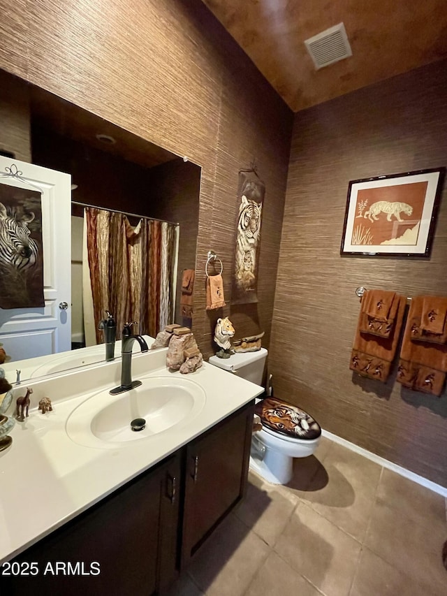 bathroom featuring toilet, tile patterned flooring, vanity, and a shower with shower curtain