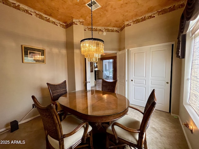 dining area with a chandelier, carpet floors, baseboards, and healthy amount of natural light