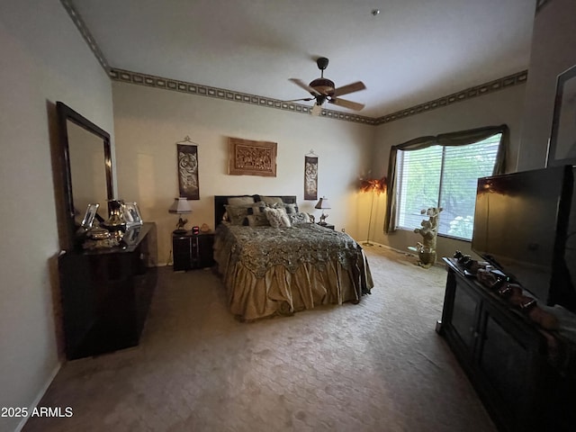 carpeted bedroom with baseboards, ornamental molding, and ceiling fan
