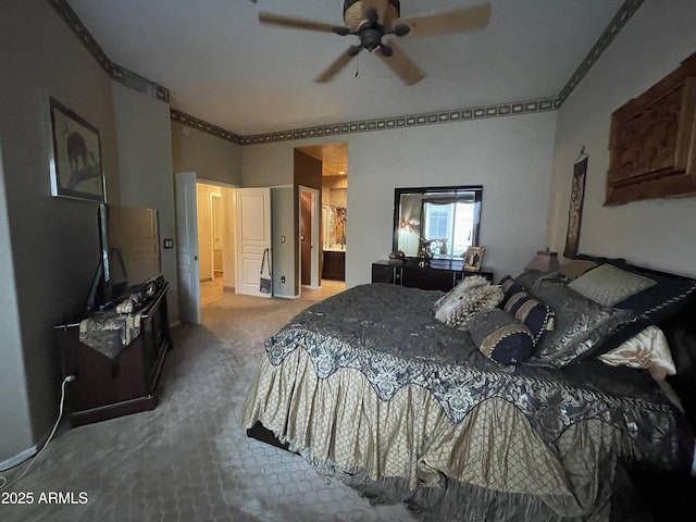 bedroom with carpet flooring, ornamental molding, ceiling fan, and ensuite bath