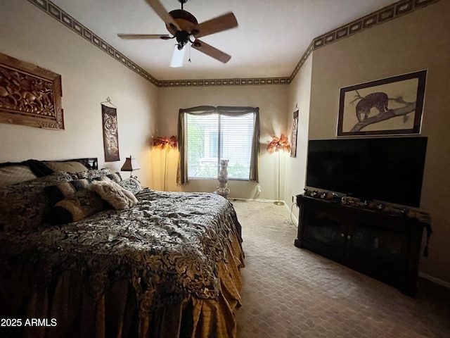 bedroom featuring ornamental molding, baseboards, and a ceiling fan