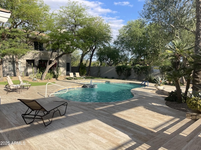 view of swimming pool featuring fence, a patio, and a deck