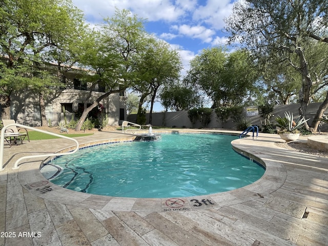 view of swimming pool featuring fence and a patio