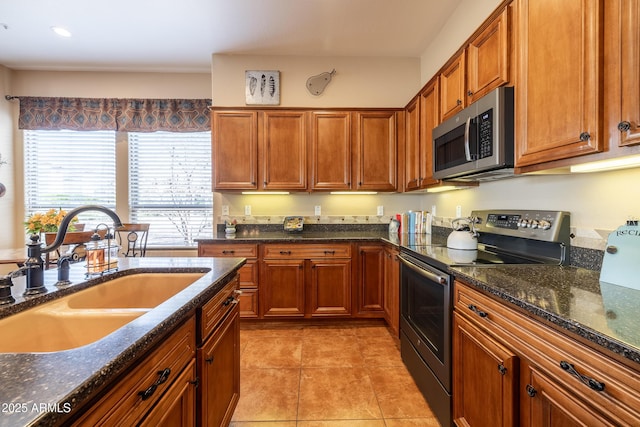 13050 W Pinnacle Vista Dr, Peoria, AZ 85383 - kitchen with appliances with stainless steel finishes, sink, light tile patterned floors, and dark stone counters