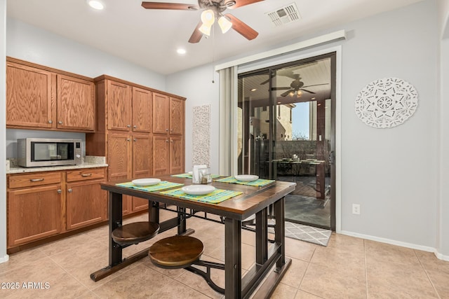 dining space with light tile patterned floors, recessed lighting, a ceiling fan, visible vents, and baseboards