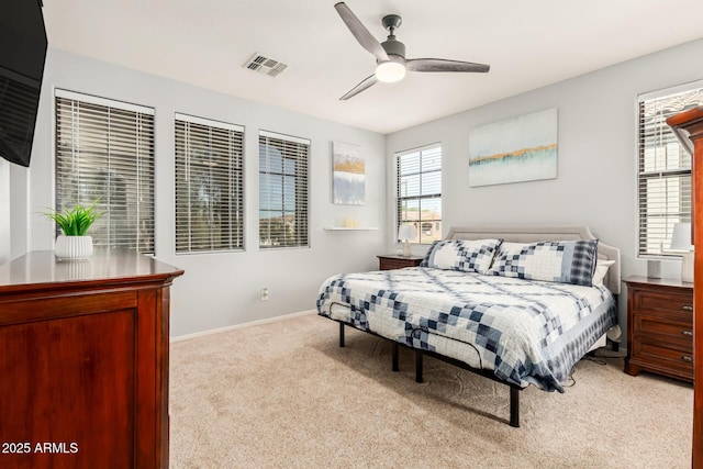 bedroom featuring carpet floors, baseboards, visible vents, and a ceiling fan