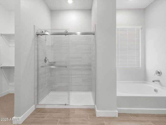 17621 W Pierson St, Goodyear, AZ 85395 - bathroom with a bath, a stall shower, wood finish floors, baseboards, and recessed lighting
