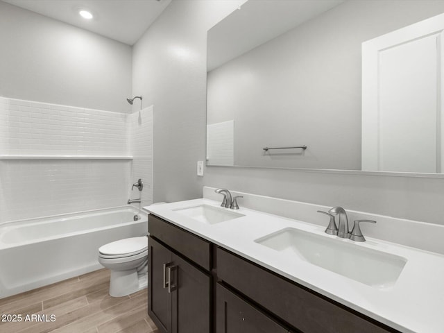 17621 W Pierson St, Goodyear, AZ 85395 - full bath featuring toilet, double vanity, wood finished floors, shower / bathtub combination, and recessed lighting