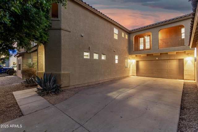 9350 W Williams St, Tolleson, AZ 85353 - view of front of home featuring a garage, stucco siding, concrete driveway, and a tile roof