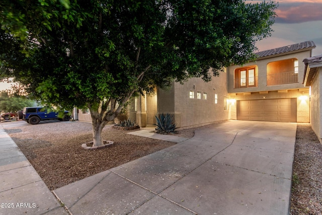 9350 W Williams St, Tolleson, AZ 85353 - view of front facade with driveway, stucco siding, an attached garage, and a tile roof