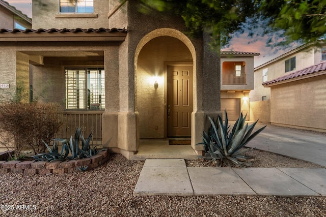 9350 W Williams St, Tolleson, AZ 85353 - doorway to property with stucco siding and a tile roof