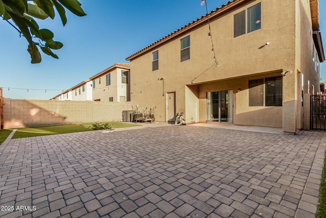 9350 W Williams St, Tolleson, AZ 85353 - back of property featuring stucco siding, a fenced backyard, a patio area, and a tile roof