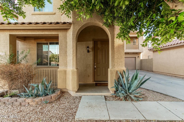9350 W Williams St, Tolleson, AZ 85353 - property entrance with stucco siding, concrete driveway, and an attached garage
