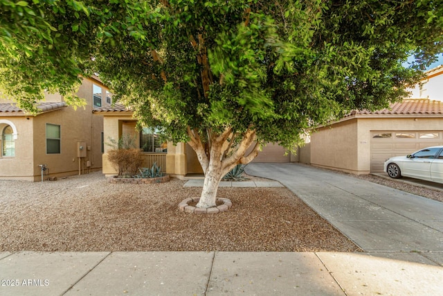 9350 W Williams St, Tolleson, AZ 85353 - view of front of home featuring a tile roof, stucco siding, and concrete driveway