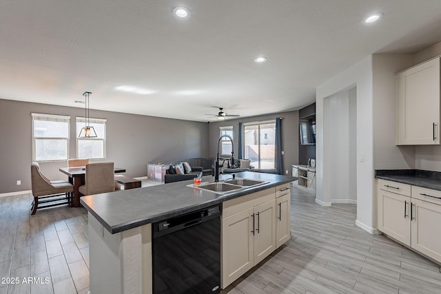 kitchen with dark countertops, dishwasher, a sink, and wood tiled floor