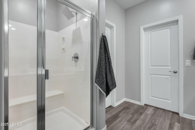 bathroom with wood-type flooring and walk in shower