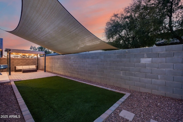 yard at dusk with a patio area