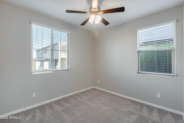 unfurnished room featuring ceiling fan and carpet floors