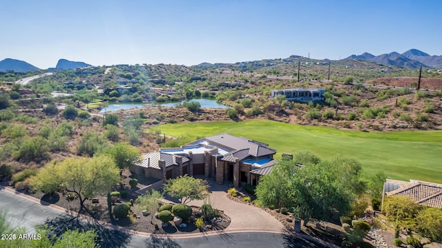 birds eye view of property with a water and mountain view