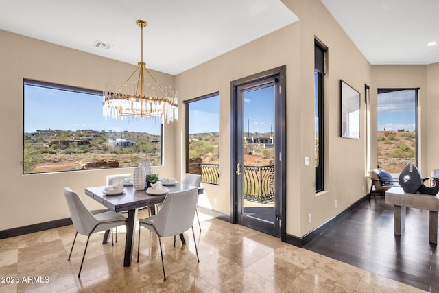 dining space featuring a chandelier, visible vents, and baseboards