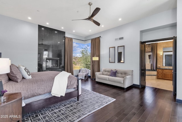 bedroom featuring recessed lighting, visible vents, wood finished floors, and a fireplace