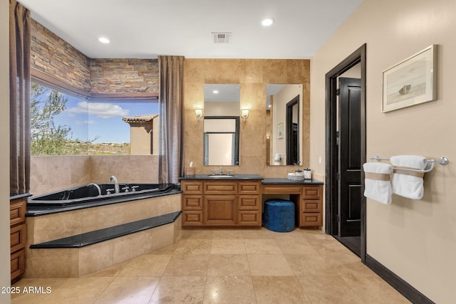 full bathroom with visible vents, tile patterned floors, baseboards, a bath, and vanity