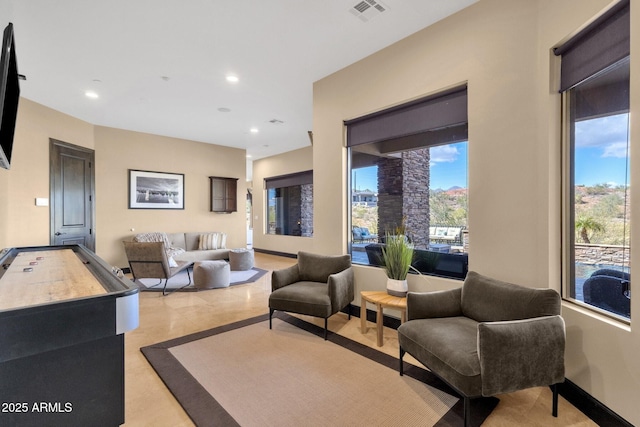 living room with visible vents, recessed lighting, and baseboards