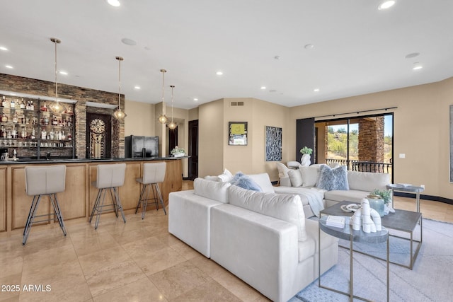 living area with wet bar, recessed lighting, and visible vents