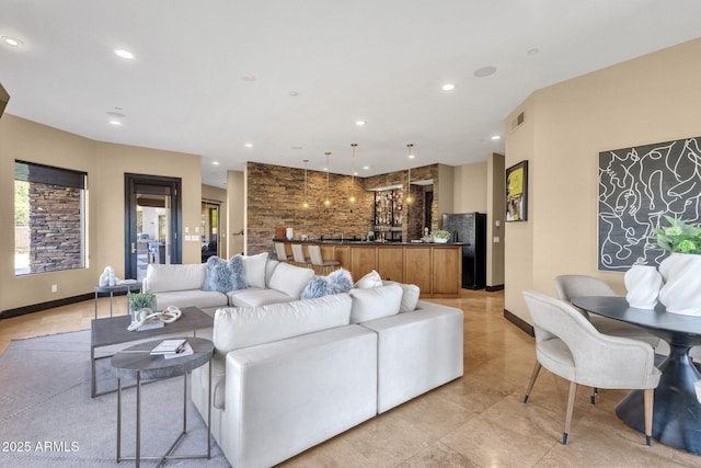 living area with indoor wet bar, visible vents, recessed lighting, and baseboards