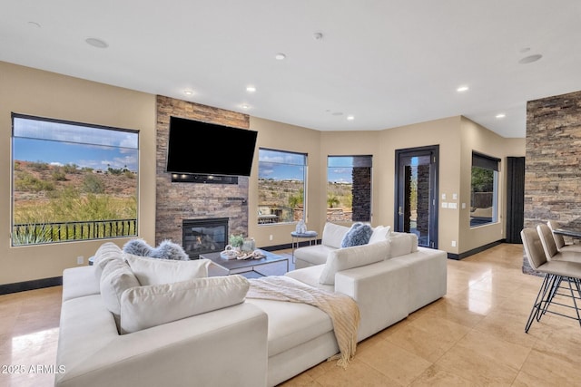 living room with recessed lighting, a fireplace, baseboards, and light tile patterned floors