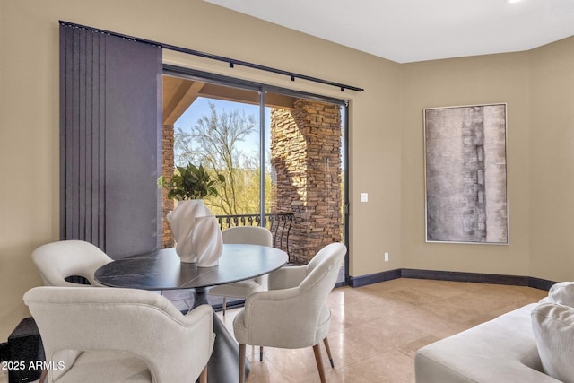 dining room with tile patterned floors and baseboards