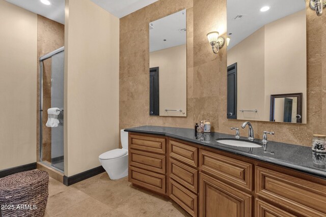 full bath featuring vanity, toilet, a shower stall, and tile patterned flooring