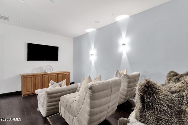 home theater room with visible vents, baseboards, and dark wood-type flooring