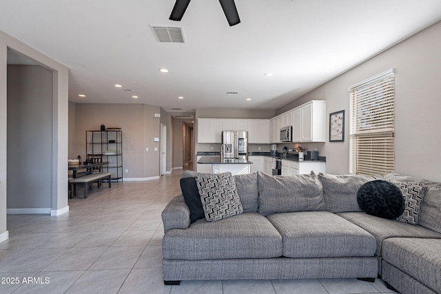 living room featuring ceiling fan and light tile patterned flooring