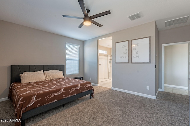 carpeted bedroom with ensuite bath and ceiling fan